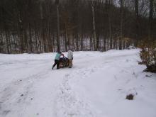 Adam and Zach sledding down after the last challenge