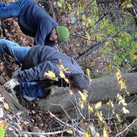 Volunteers pushing trash up the slope